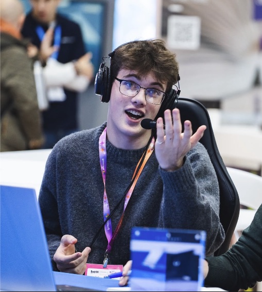 Evan, Game Master for The Lewos Tavern Halloween Table, wearing a headset at a live event